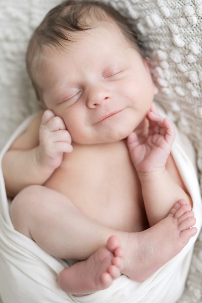 Newborn portrait of a baby sleeping. Photo taken by Tayler Enerle Photography in San Luis Obispo, California