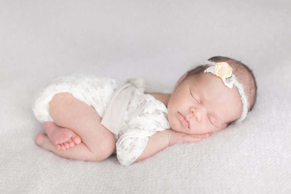Paso Robles Newborn photographer, Newborn posed on her tummy in Tayler Enerle's Los Osos, ca photography studio.