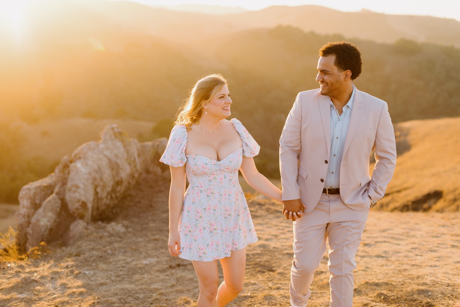 couple walking and smiling at eachother during sunset photos at Perfumo canyon, san Luis Obispo