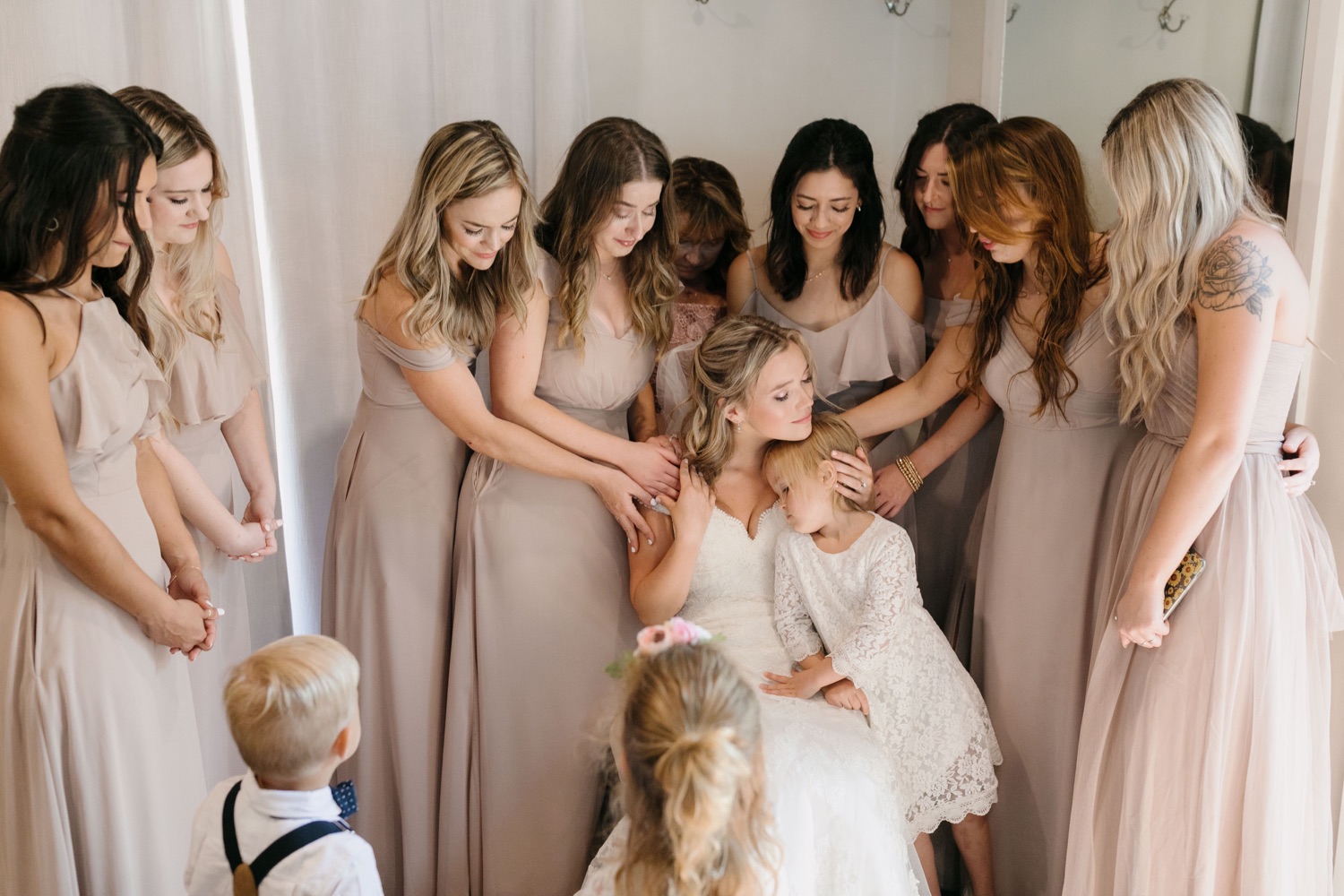 Bride and bridesmaids praying before the ceremony with her sisters