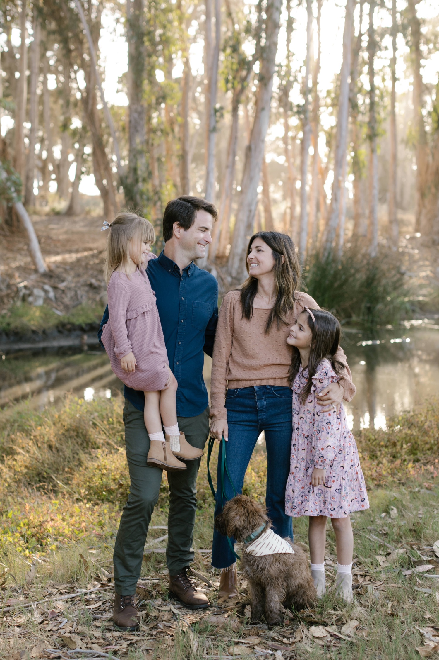family smiling at each other during family portrait in SLO county by tayler enerle