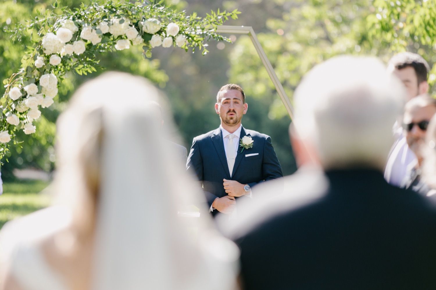 Groom getting emotional as he sees his bride walk down the aisle for the first time at walnut grove wedding