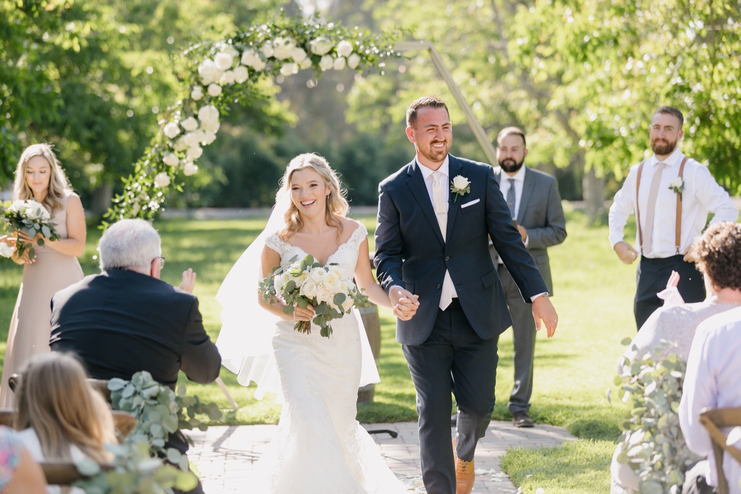 bride and groom smiling with excitement as they walk down the aisle after ceremony