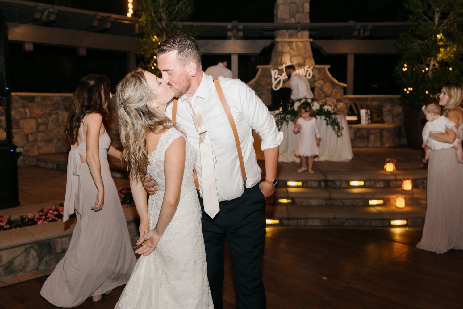 bride and groom kiss on the dance floor at their wedding reception at walnut grove