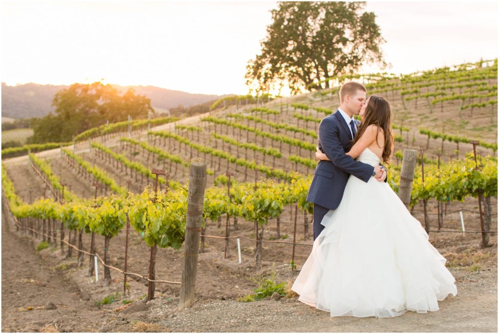 Newly married couple kiss in the vineyard at Opolo Winery wedding