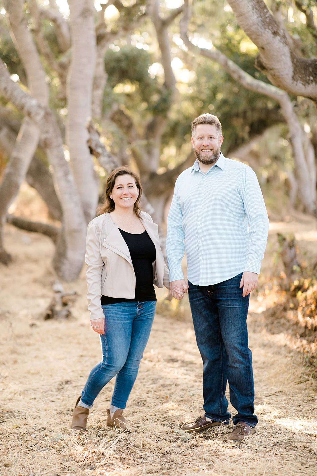 engaged couple posing hand in hand at the Oaks reserve in Los Osos, california