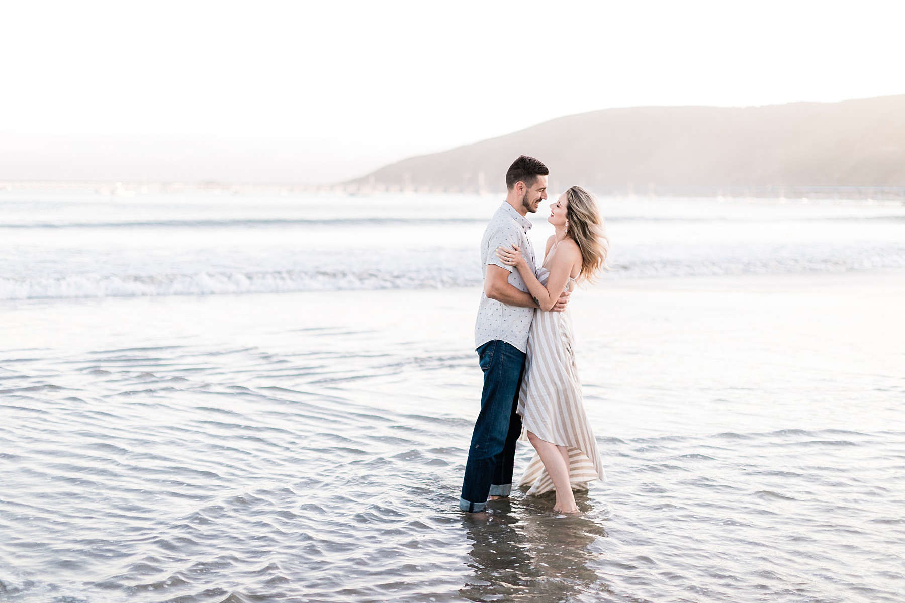 Couple laughing together at Avila beach engagement session