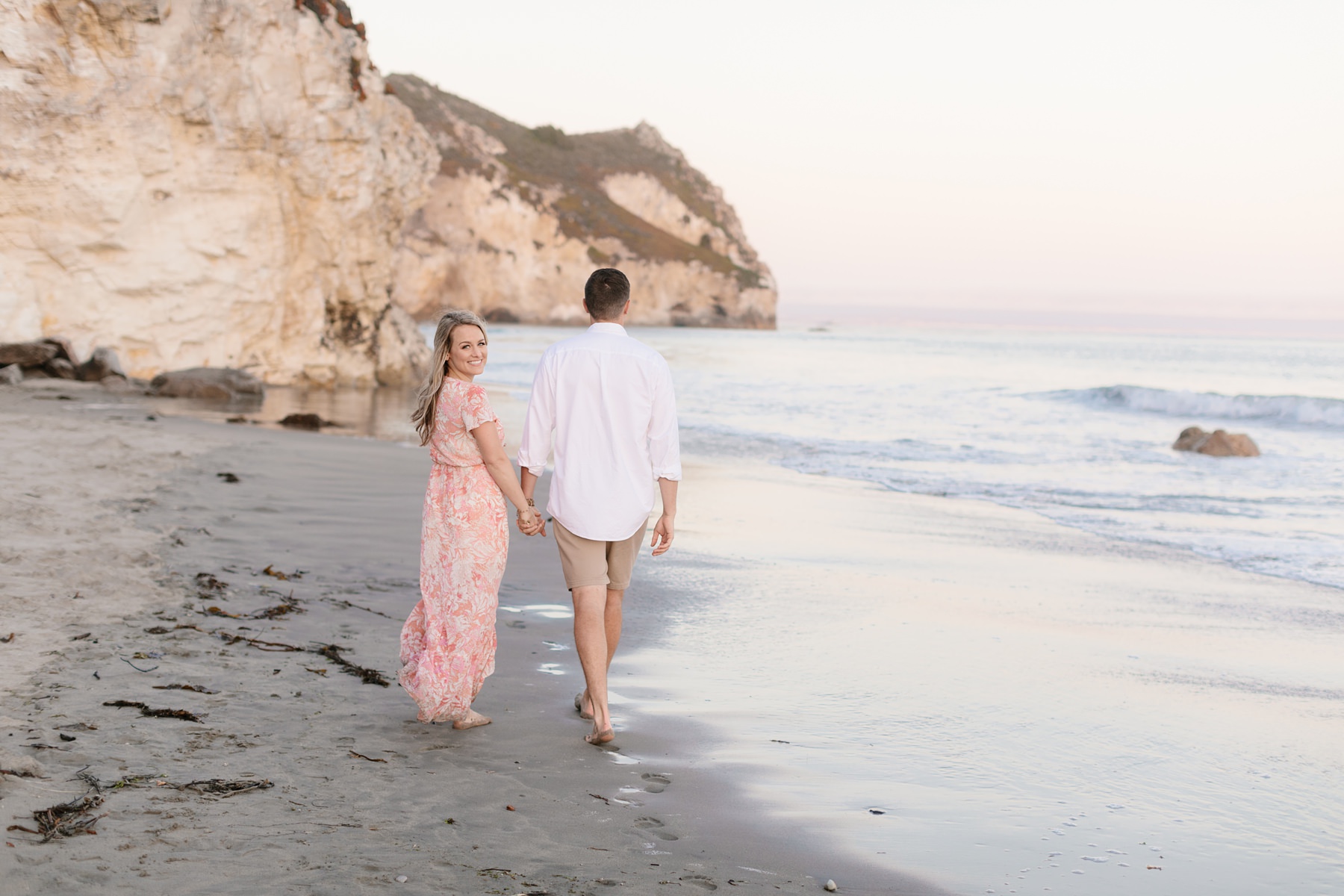 couple walking at Avila beach engagement session