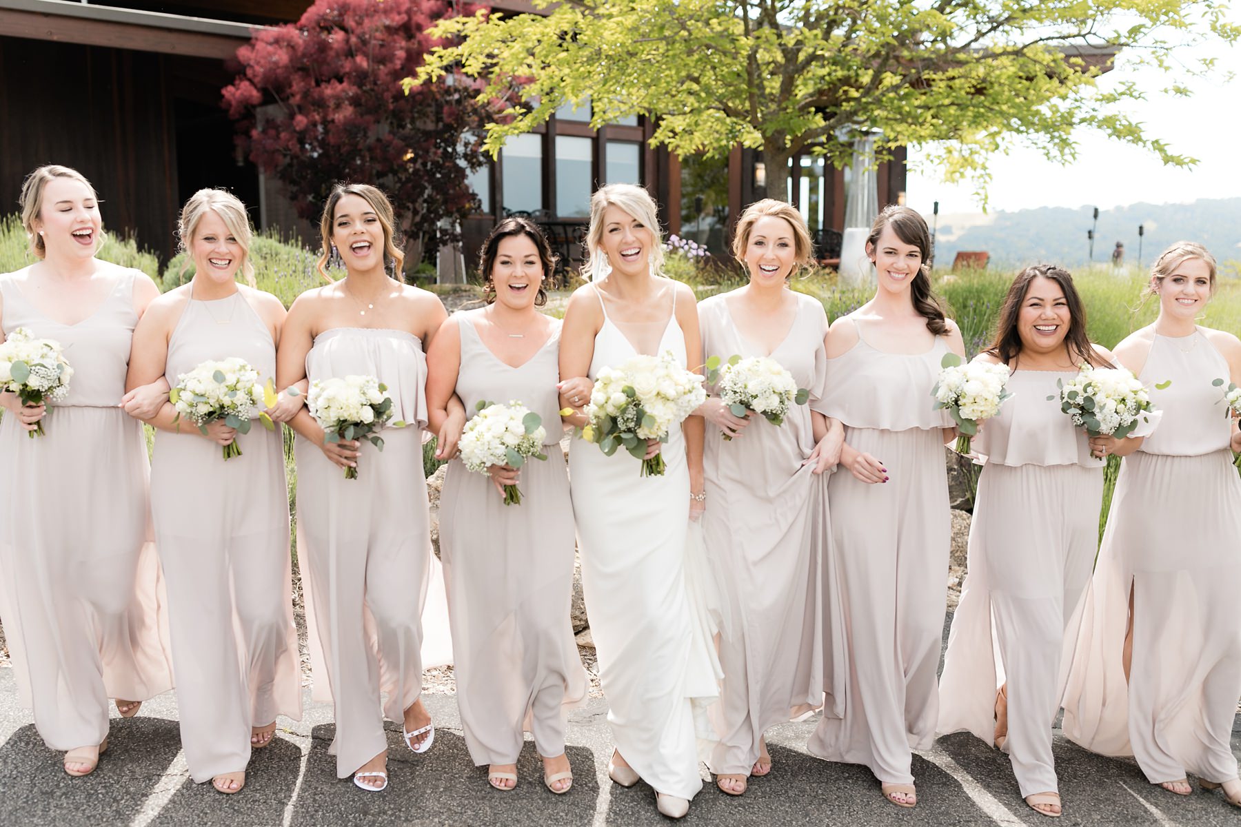 Bride and bridesmaids laugh and post together for portraits at Opolo winery wedding