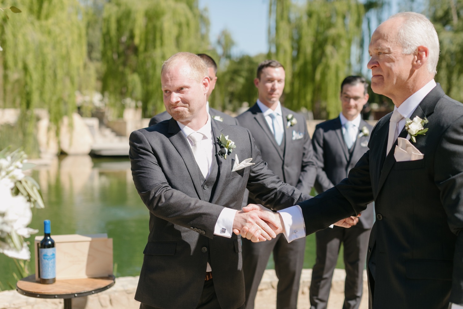 Father of the bride shaking hands with the groom at their wedding at Terra Mia