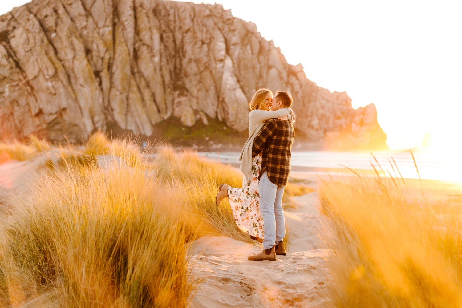 sunset photo of couple at their engagement session in Morro Bay rock, california 