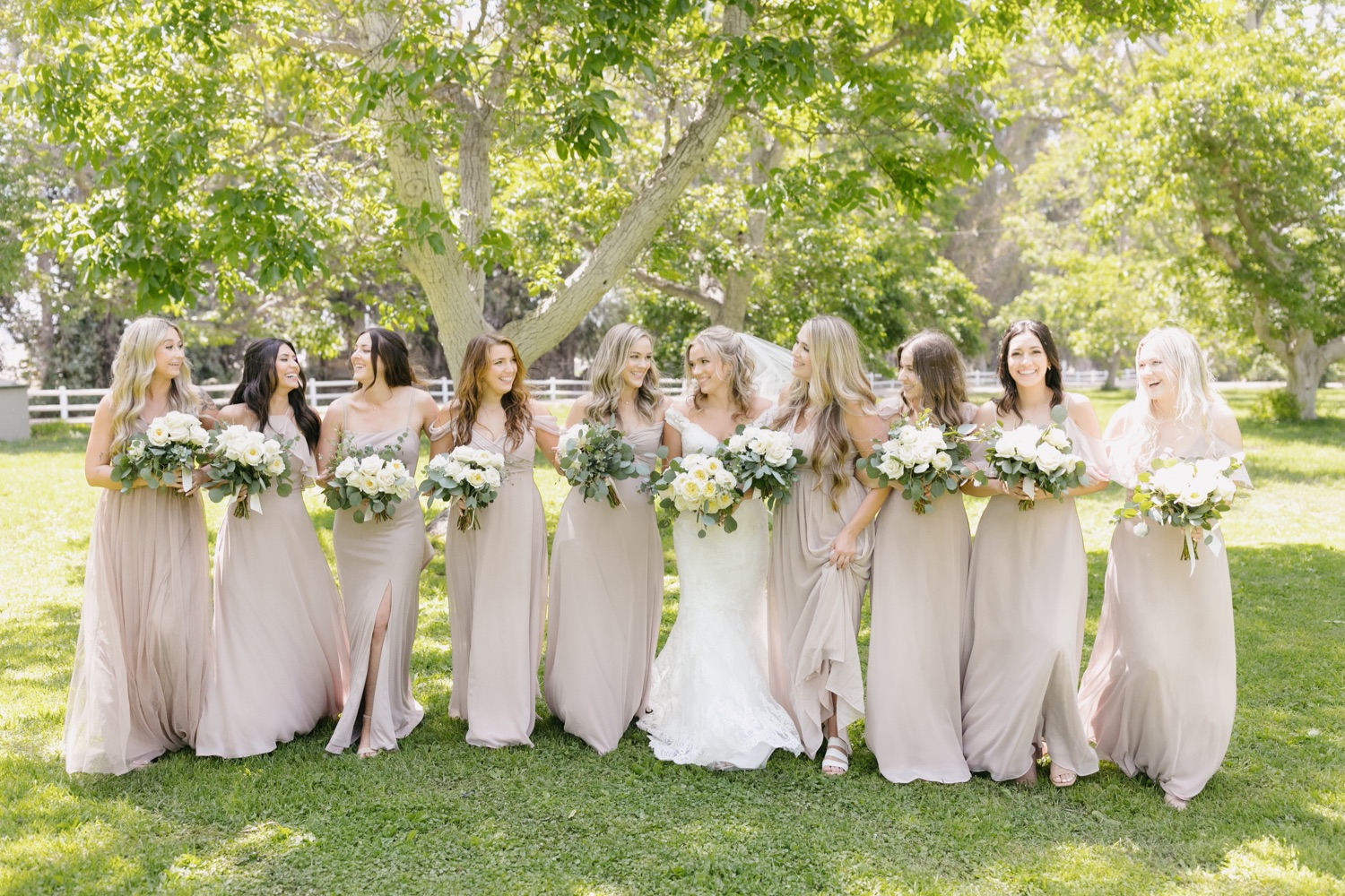 Bridesmaids walking and laughing together at walnut grove wedding by tayler enerle