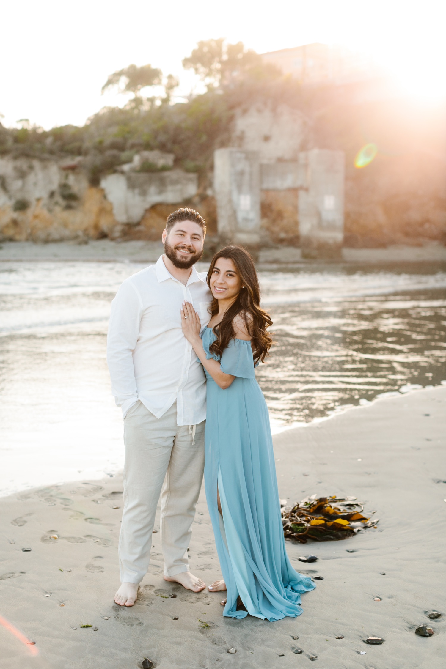 Couple embraces at Avila beach engagement session by Tayler enerle photography