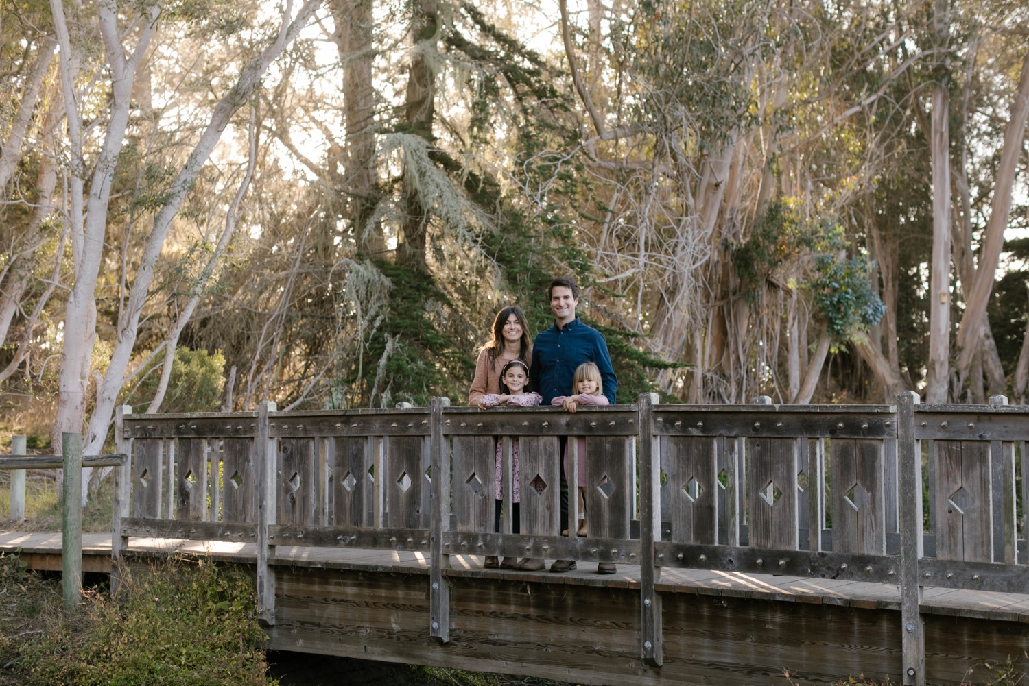 family posing on a bridge at Sweet springs nature reserve in Los Osos, California