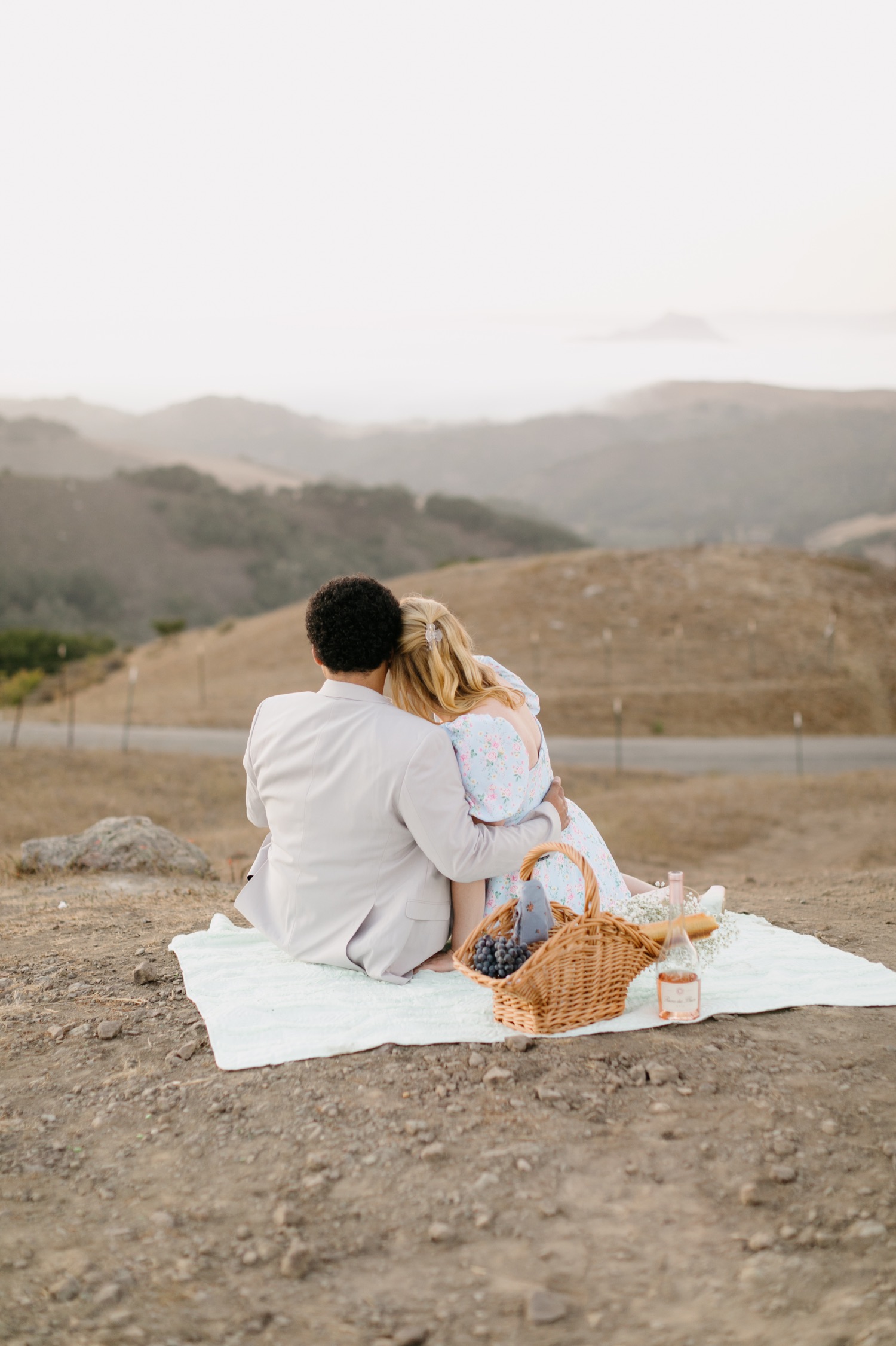 Couple sitting and enjoying the view of san luis obispo county at their engagement session