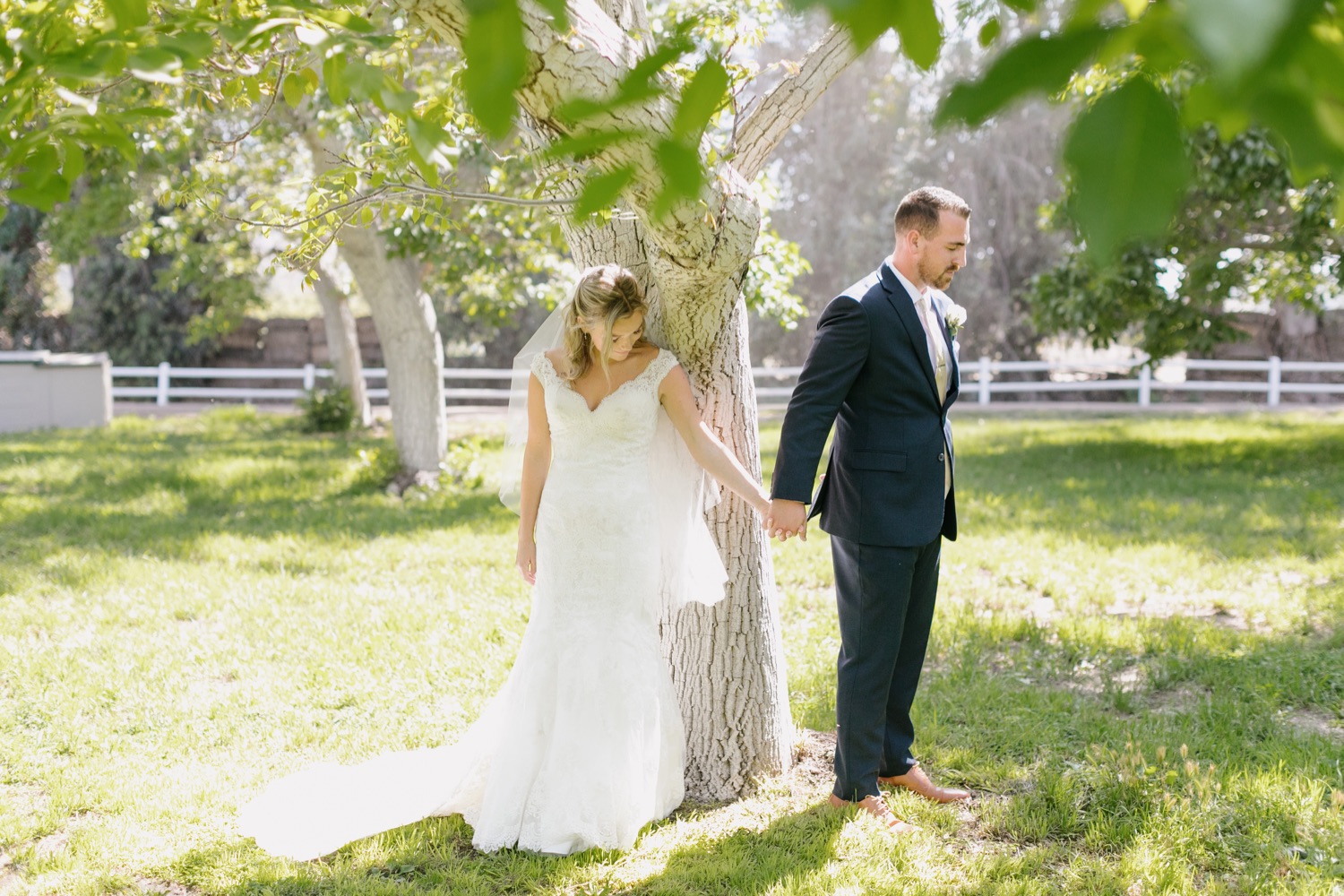 Bride and groom pray together for first touch before wedding ceremony at walnut grove