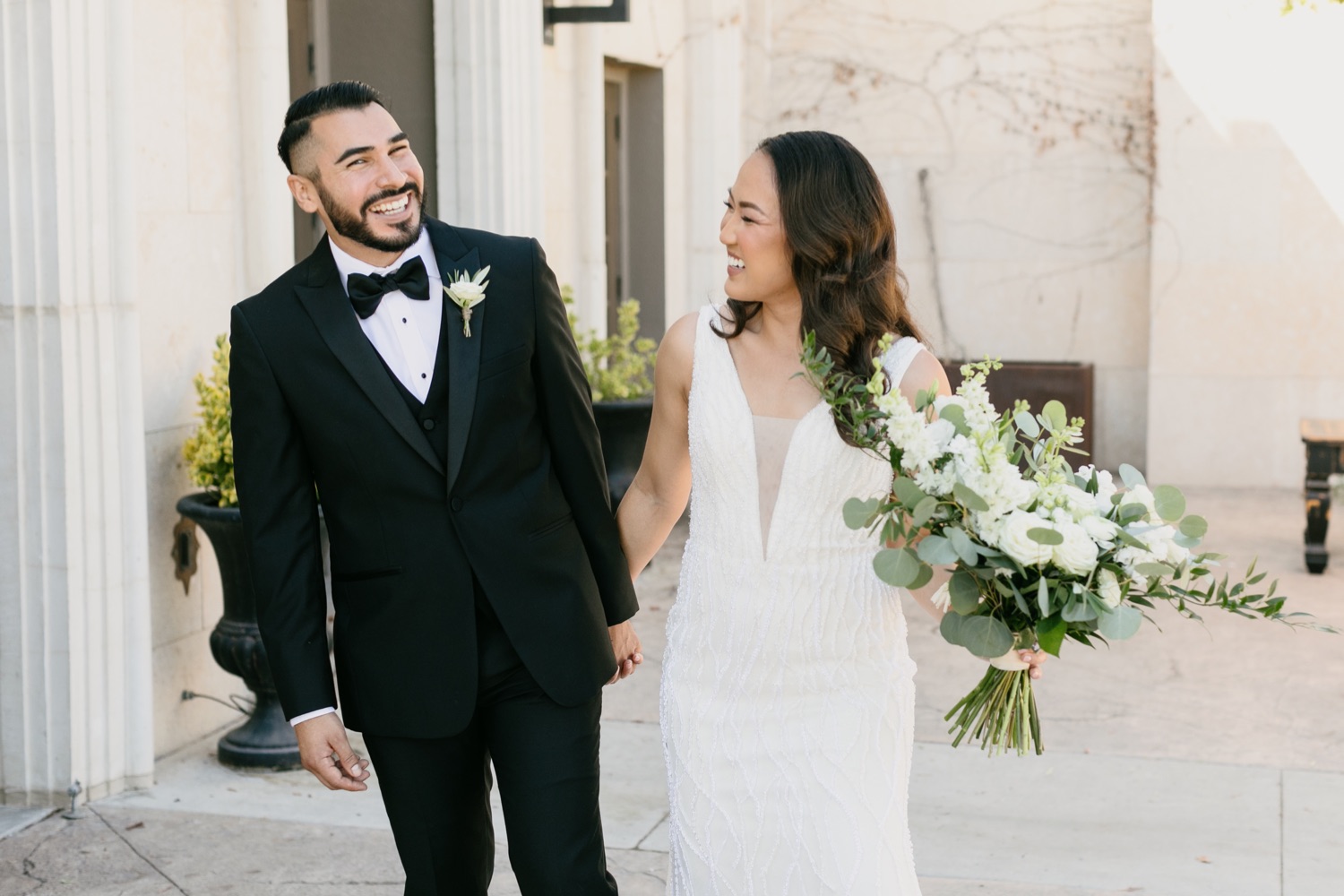 Tooth and nail winery wedding with bride and groom walking together by tayler enerle photography