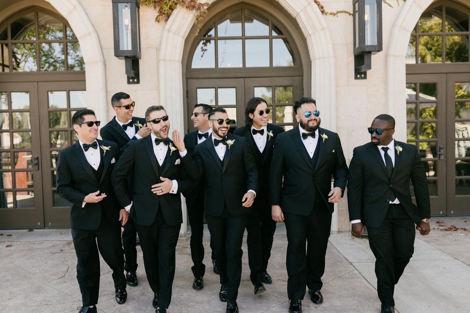Groomsmen walking together for wedding portraits at tooth and nail winery
