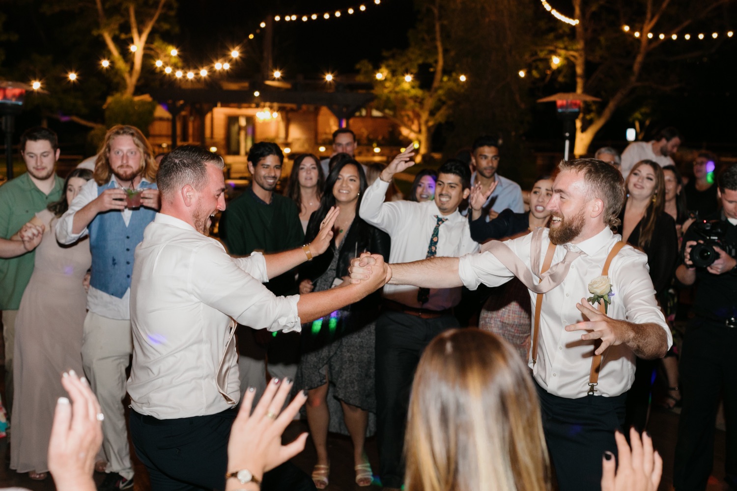 groom and his brother dancing together at walnut grove wedding reception