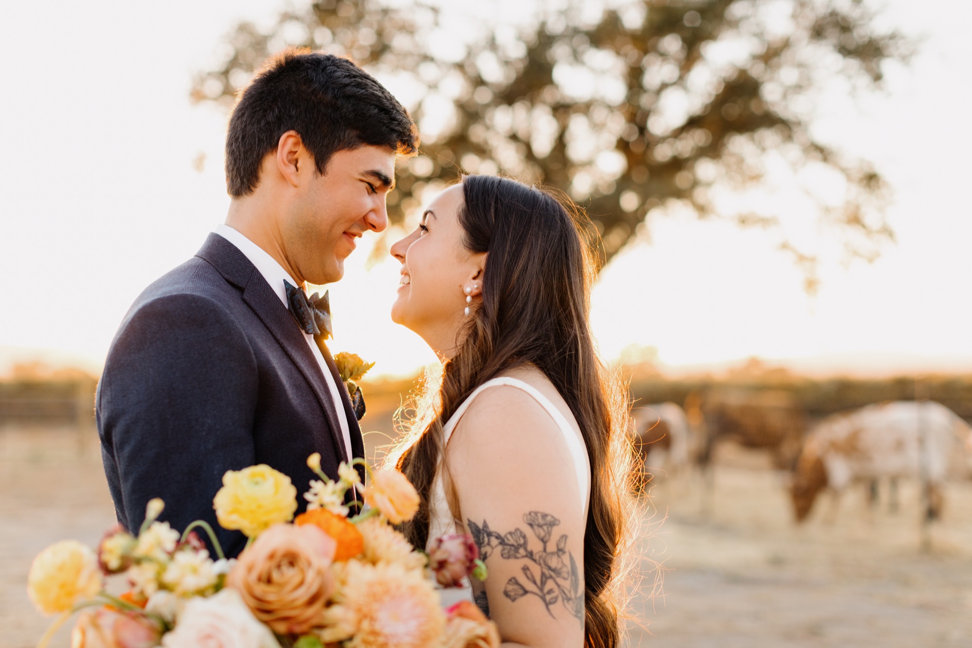 close up of couple smiling at eachother during sunset portraits at their 1800 el pomar wedding reception