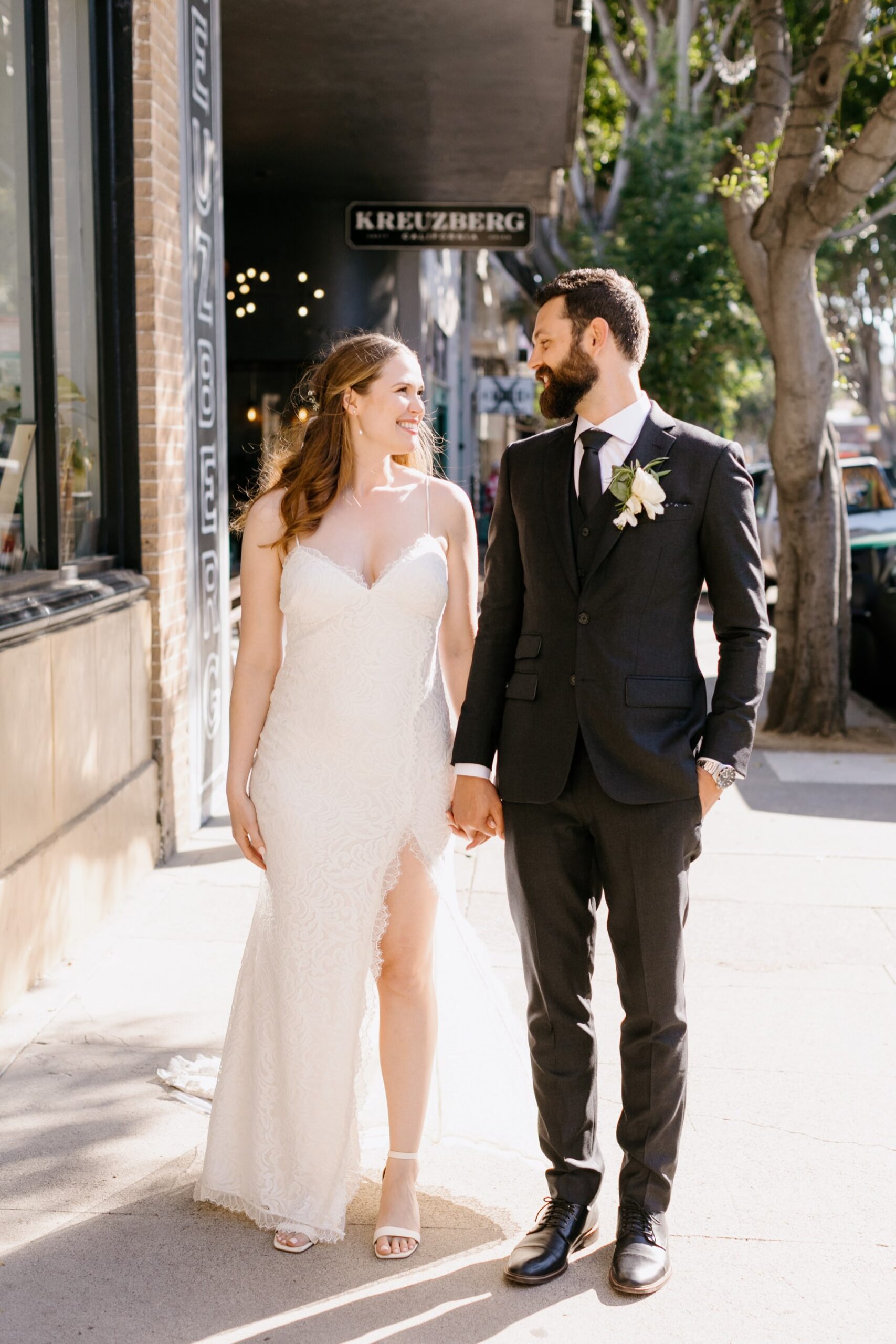 couple walking together in downtown san luis obispo during their wedding reception at the Penny in slo