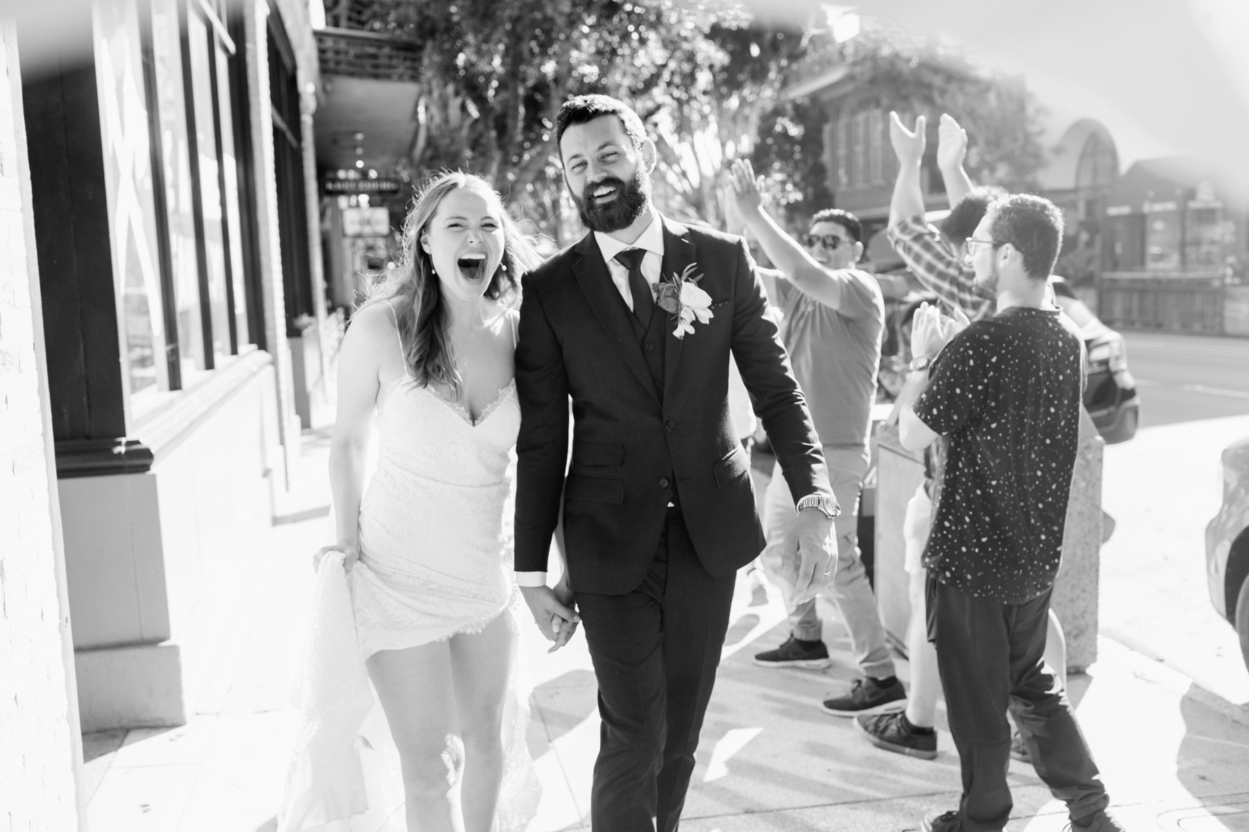 newlywed couple walking around downtown san luis obispo for sunset hour during their wedding reception at the Penny in downtown slo