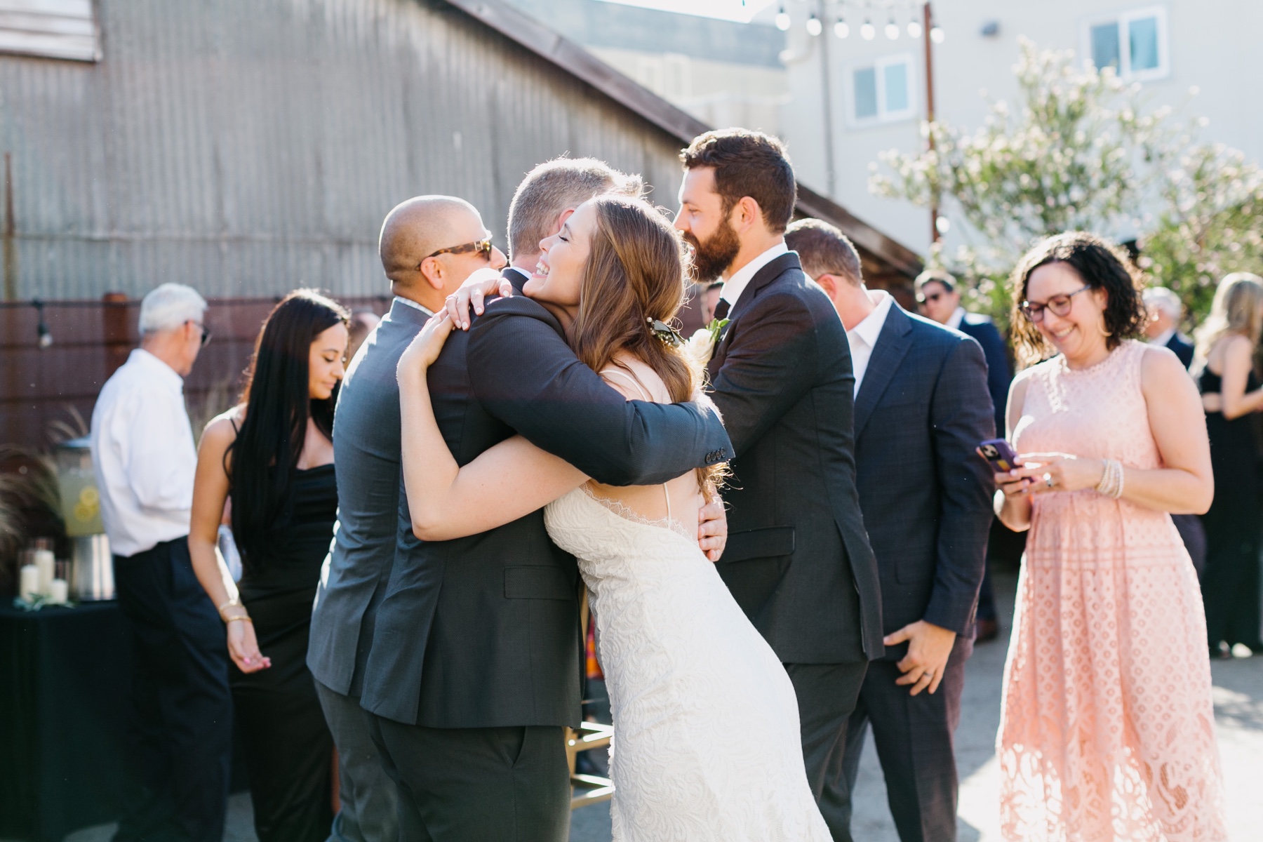 a bride and groom greeting their guests at their downtown san luis obispo wedding reception at the penny in slo