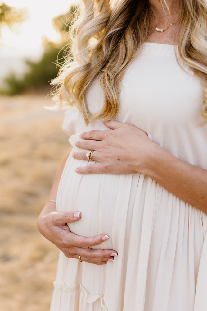 blonde mother embracing her pregnant belly at San Luis obispo maternity session