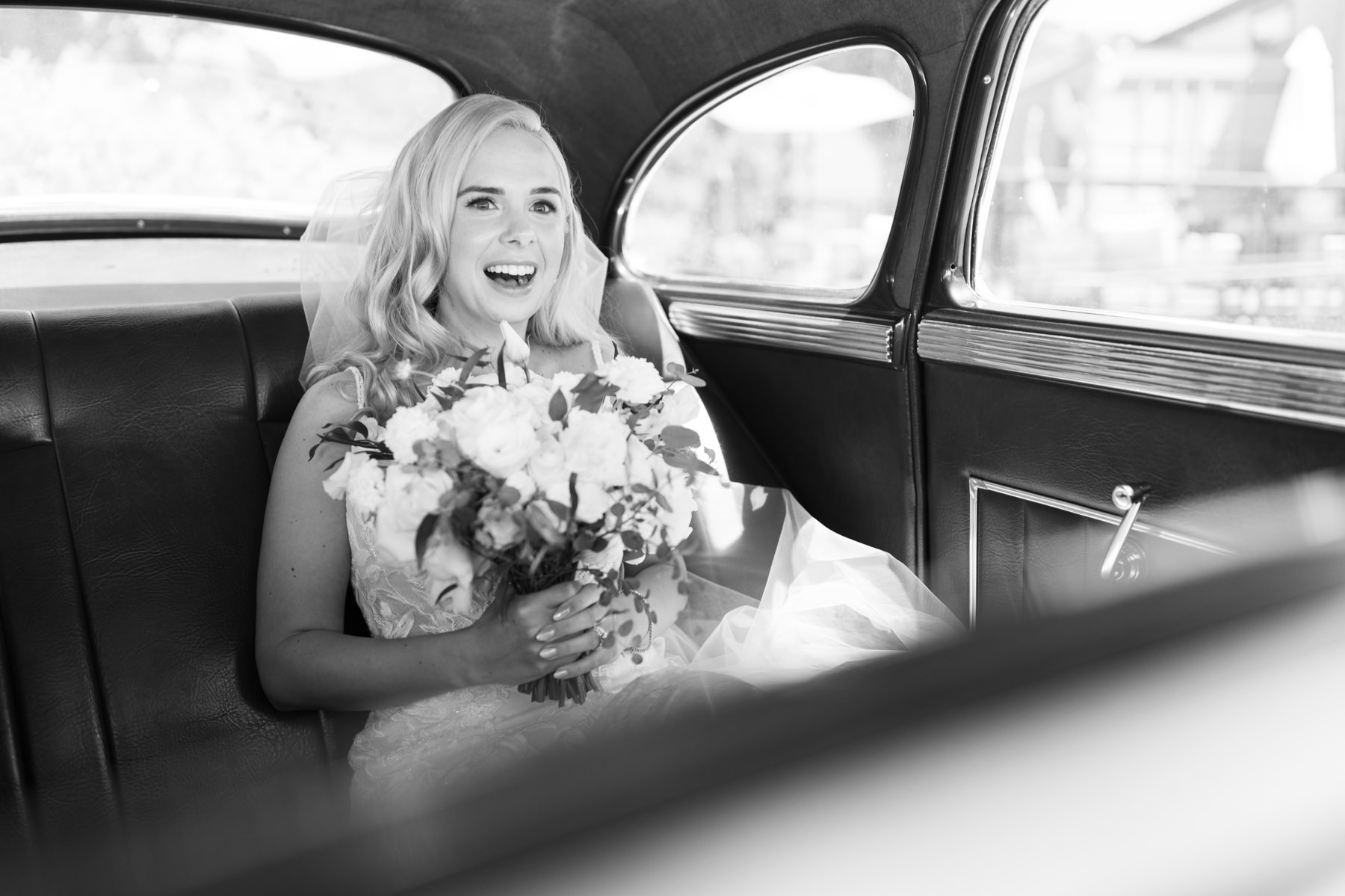 Bride getting ready to go to her ceremony, taking a vintage car to her ceremony at Cass Winery